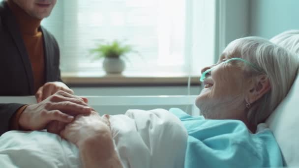 Tilt Shot Adult Son Holding Hand Sick Elderly Mother Talking — Vídeo de stock