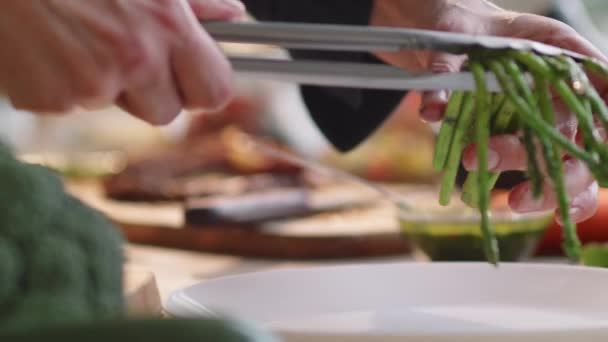 Close Shot Hands Restaurant Chef Using Metal Tongs While Putting — Stock Video