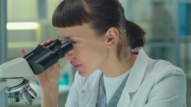 Tilt Shot Female Scientist Working Microscope Taking Notes While Conducting — Vídeos de Stock