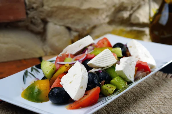 Greek salad with olives and olive oil. Homemade food. Rustic.