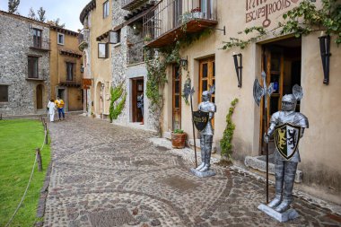 Tlaxcala, Mexico - June 2021: Armor guarding the entrance of an escape room in the town of Val'Quirico, a place where tourists can enjoy amenities and international food restaurants. clipart