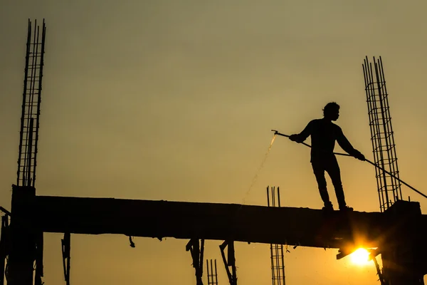 Silhouette of constructionworker on constructionsite Stock Image