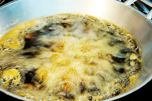 Boiling oil in pan.