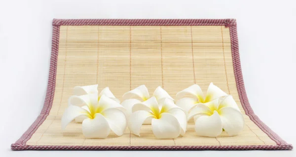 White flowers on bamboo sheets . — Stok fotoğraf