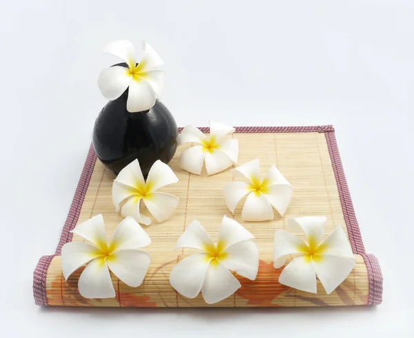 White flowers on bamboo sheets . — 图库照片