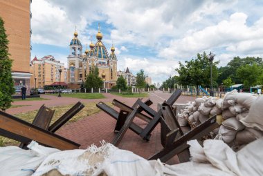 Church, anti-tank hedgehogs and barricades in Kyiv, Ukraine clipart