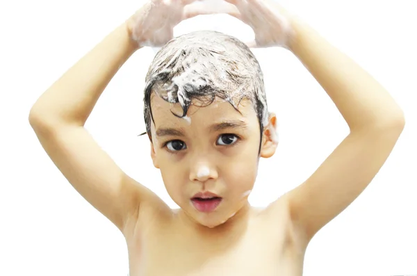 Little boy playing with shampoo foam — Stock Photo, Image