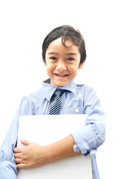 Liten business pojke håller en stor bok — Stockfoto