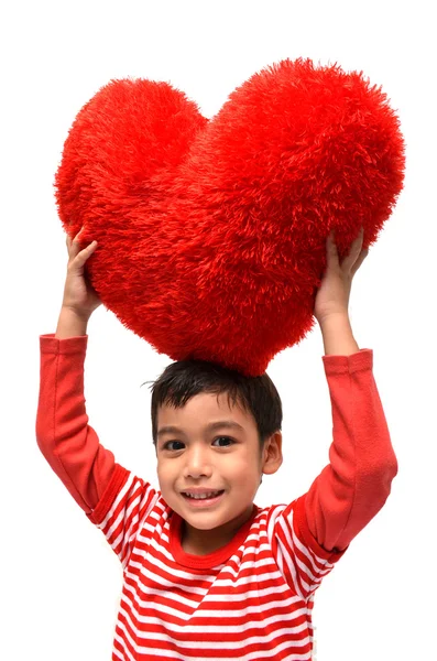 Menino segurar travesseiro coração vermelho — Fotografia de Stock