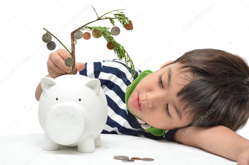 Little boy saving money in piggy bank money growing up as tree