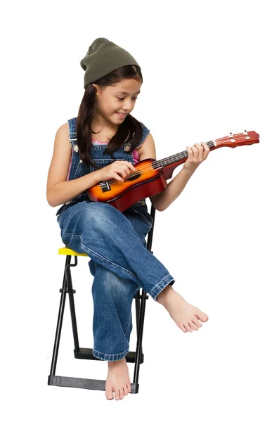 Little girl playing ukulele on white background — Stock Photo, Image
