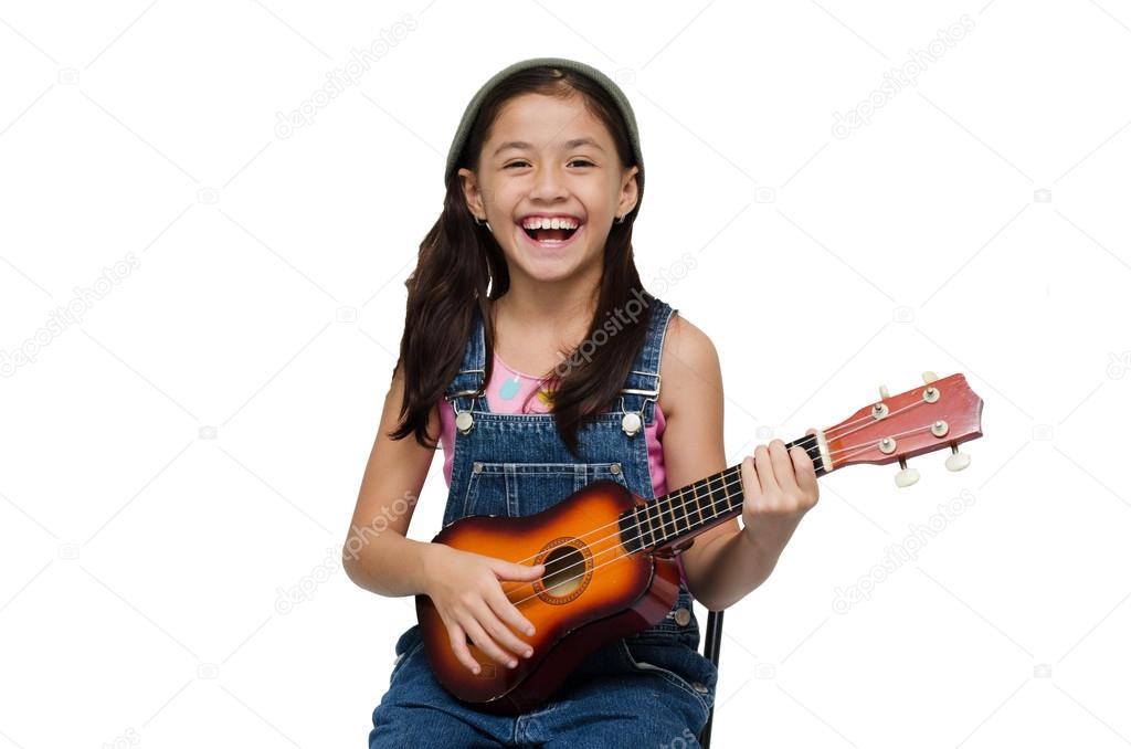 Little girl playing ukulele on white background
