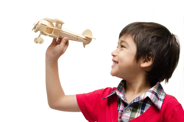 Little boy playing with a toy airplane. Isolated on white backgr — Stock Photo, Image