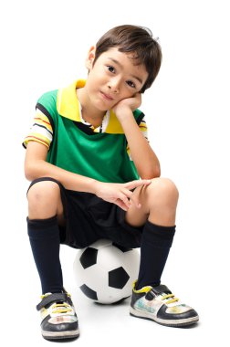 Little boy sitting on football on white background clipart