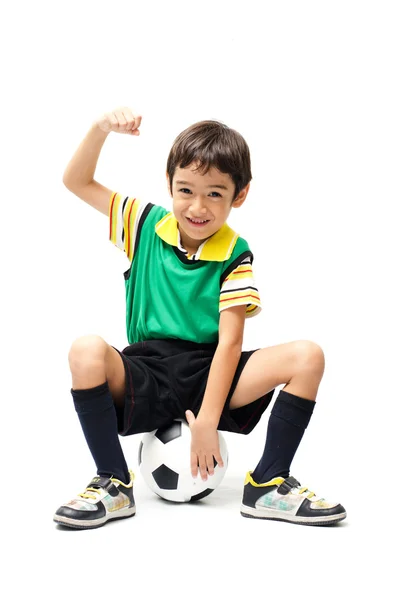 Menino sentado no futebol no fundo branco — Fotografia de Stock