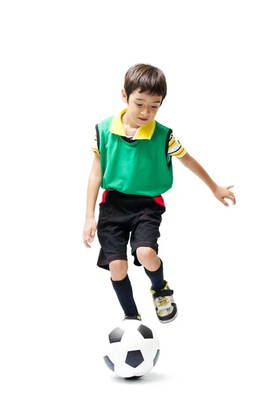 Menino chutando futebol verde no fundo branco — Fotografia de Stock