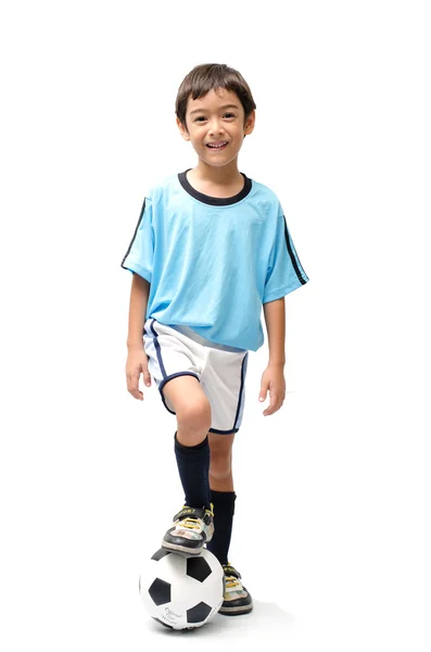 Liten pojke sparkar fotboll på vit bakgrund — Stockfoto
