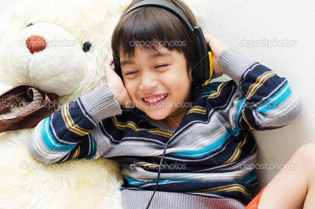 Little boy listening the music with headset