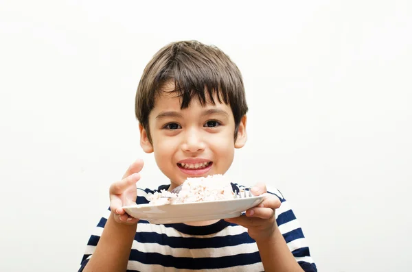 Mały chłopiec pokazano szczęśliwy twarz ryżu — Zdjęcie stockowe