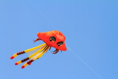 Octopus kite on blue sky clipart