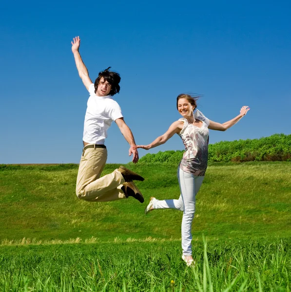 Cheerful girl and boy are jumping — Stock Photo, Image