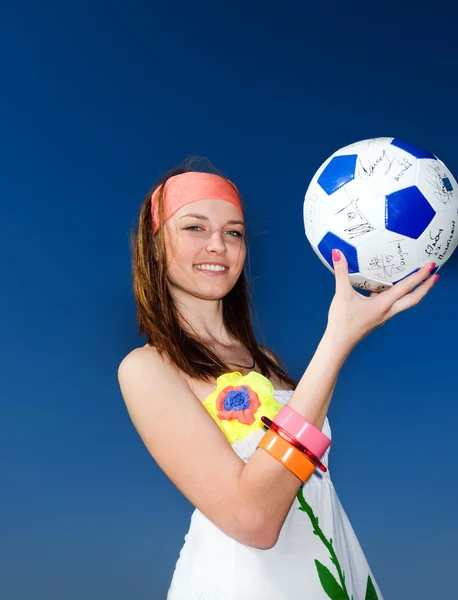 Girl with ball on blue background Stock Photo