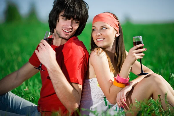 Girl in kerchief and boy with wineglasses — Stock Photo, Image