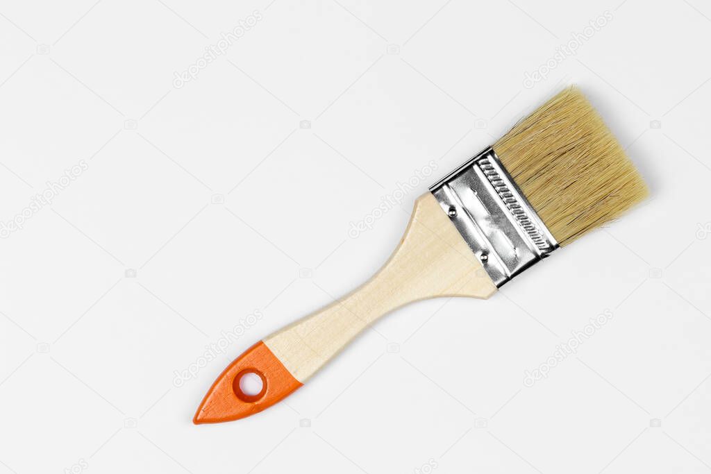 paint brush close-up against a white background, natural shadow, copy space, top view
