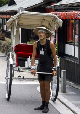 A traditionalJapanese rickshaw in Arashiyama district clipart