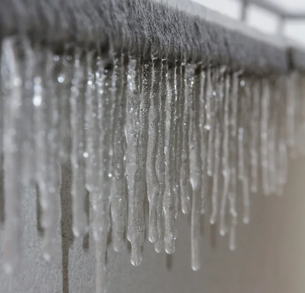 Icicles hanging from balcony — Stock Photo, Image