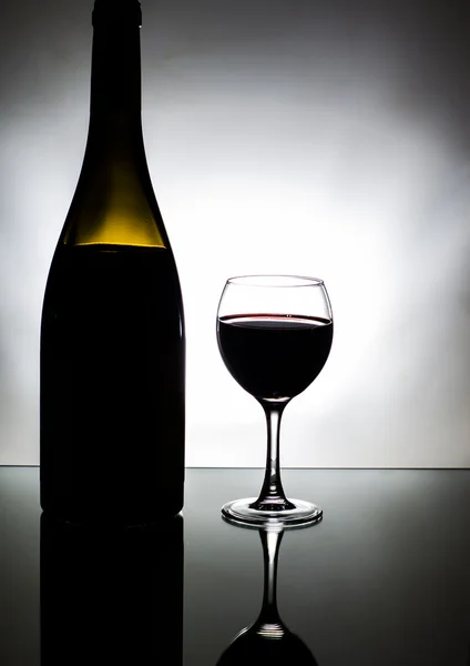 Glass and bottle of red wine — Stock Photo, Image