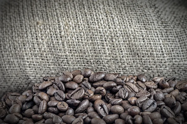 Wool bag full with coffee beans — Stock Photo, Image