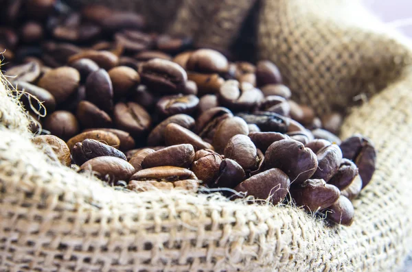 Wool bag full with coffee beans — Stock Photo, Image