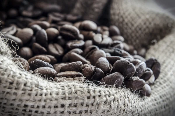 Wool bag full with coffee beans — Stock Photo, Image