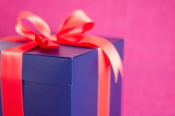 Blue present box with red ribbon isolated — Stock Photo, Image