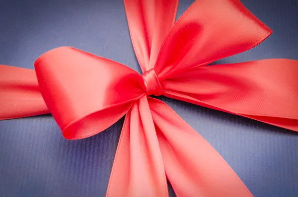 Classic red ribbon on blue background — Stock Photo, Image