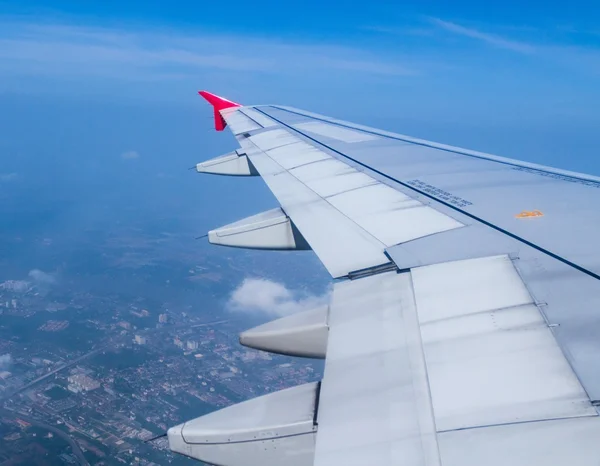 Aircraft wing on during flying above ground — Stock Photo, Image