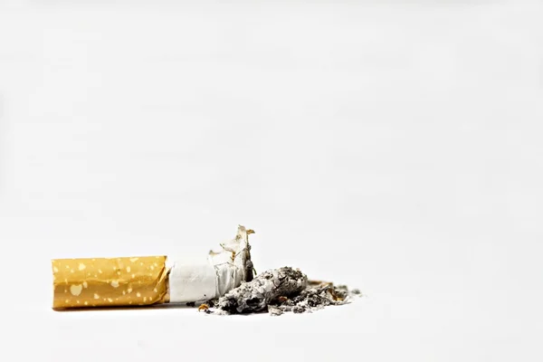 Single cigarette butt with ash on white background — Stock Photo, Image