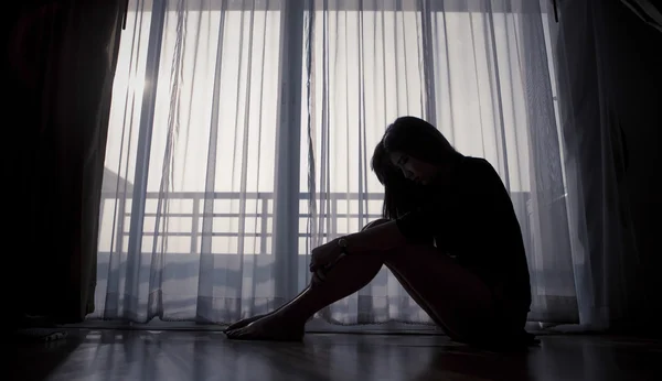 Sad woman sitting alone — Stock Photo, Image