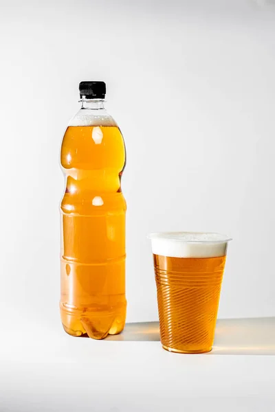 Fresh Light Draft Beer Plastic Bottle Beer Foam Poured Glass — Stock Photo, Image