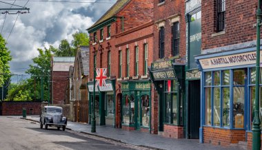 A Vintage Morris Eight car parked along a Victorian village street at the Black Country Living Museum, Dudley.