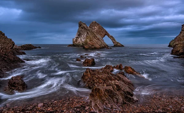 Bow Fiddle Rock is a natural sea arch near Portknockie on the Moray coast of Scotland