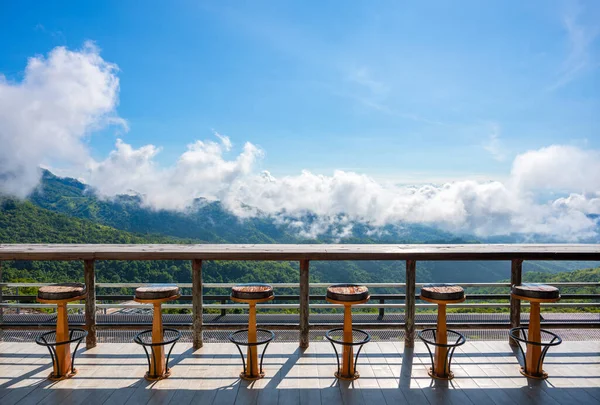The wooden counter table and chair with mountain view point at Pino latte, Khao kho, Phetchabun, Thailand.