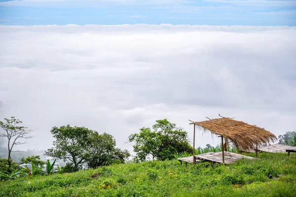 Thai bamboo bed for relaxation overlooking the clouds and mist in the morning. Phu Thap Berk, Phetchabun, in Thailand.