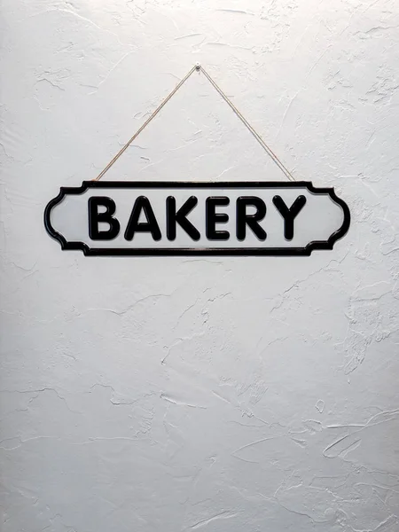 Sign Hanging Word Bakery Old White Plaster Wall — Stock Photo, Image