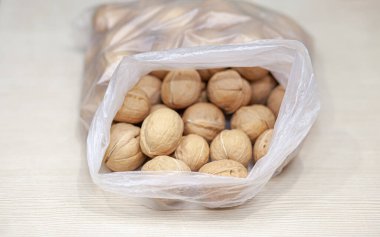 Beyaz arka planda bir torba dolusu ceviz. Yüksek protein ve protein içerikli sağlıklı organik yiyecekler..