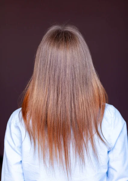 Девушка с длинными, прямыми и красивыми каштановыми волосами. Уход за волосами на дому — стоковое фото