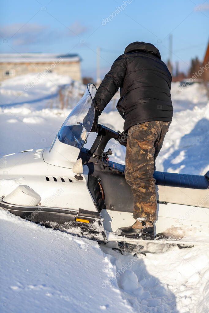 Snowmobile in winter conditions. Snowmobiling in winter in the north. Extreme kind of winter outdoor sport.