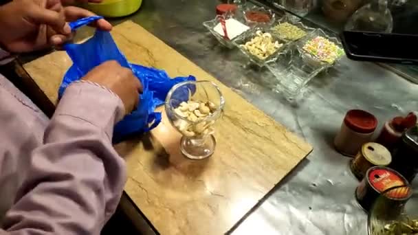 Putting Cashew Glass Short Video Clip — стоковое видео