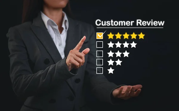 Attractive professional businesswoman hands rating five star icon with excellent rating for service evaluation on virtual touch screen interactive. Customer satisfied survey experience concept